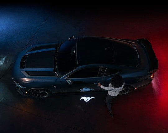 2024 Ford Mustang® Dark Horse™ model with a driver approaching the vehicle | Paoli Ford in Paoli PA